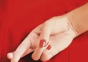 potada de la novela de sophie stava la mentirosa en la que se ve el vestido de una mujer, color rojo, que esta de espaldas y se le ve la mano con los dedos cruzados
